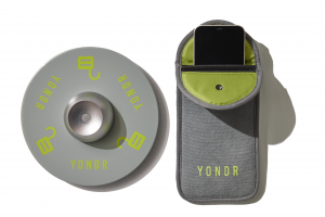 Yondr unlocking tool and a Yondr pouch with a phone inside