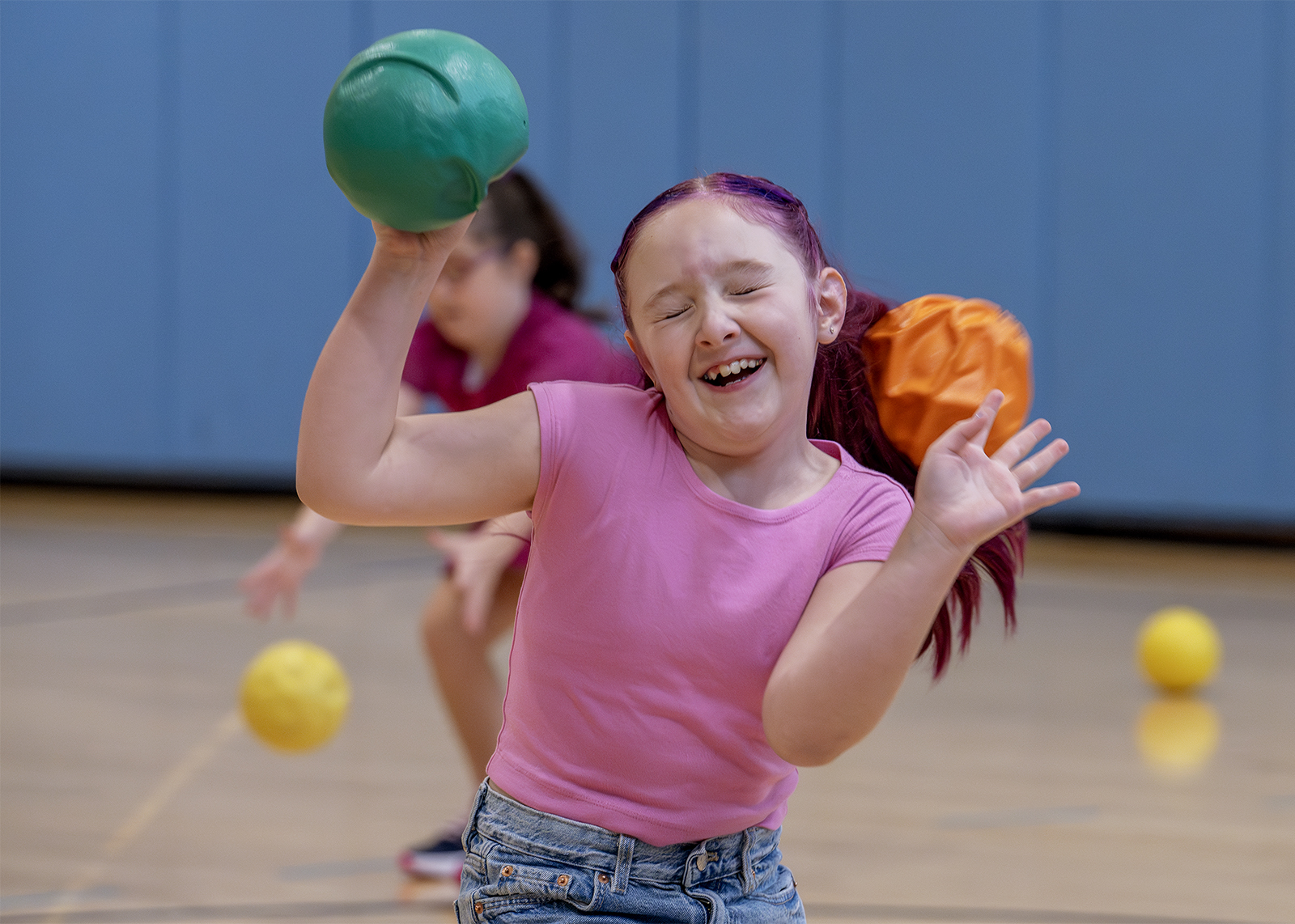 girl closes her eyes while smiling in dodgeball