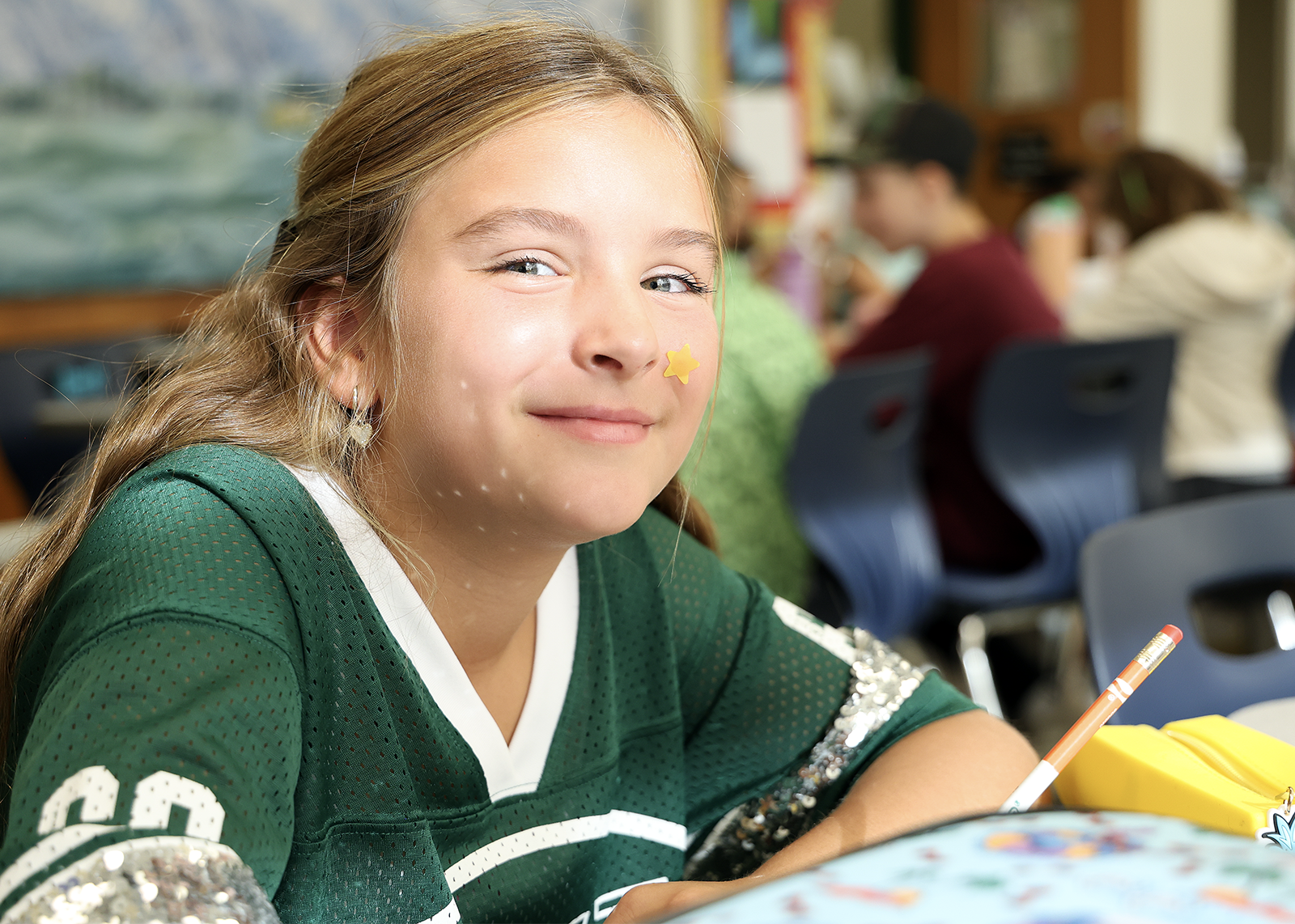 elementary student smiles in class