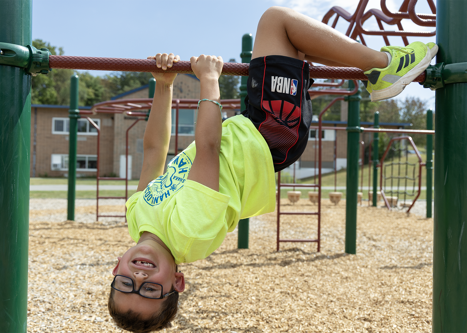 elemtary student upside on playground
