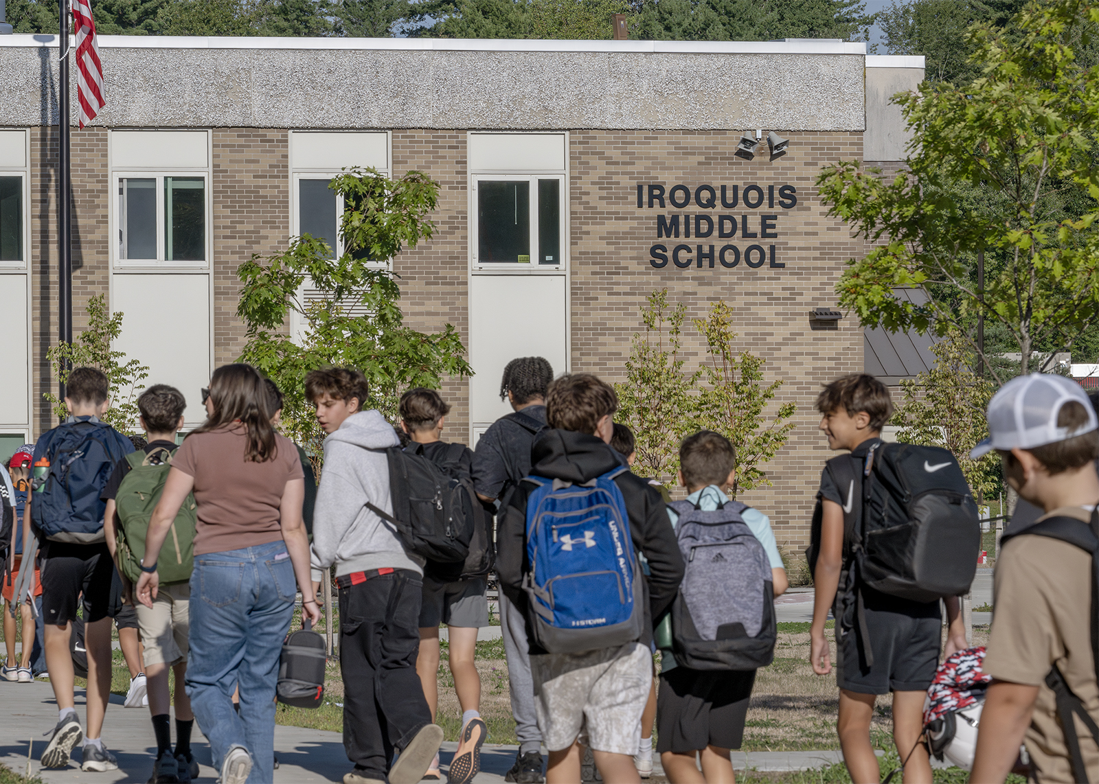 backs of kids in foreground with Iroquois Middle School sign in focus