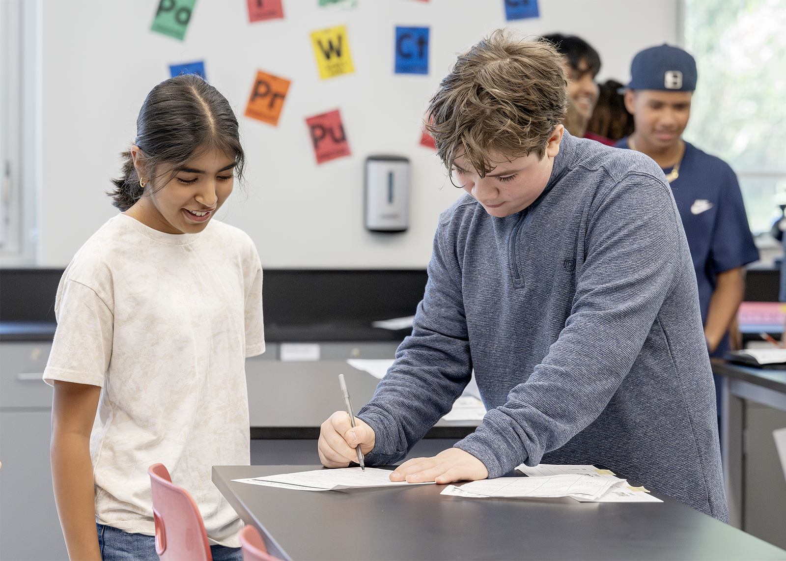 two middle school students work on a project