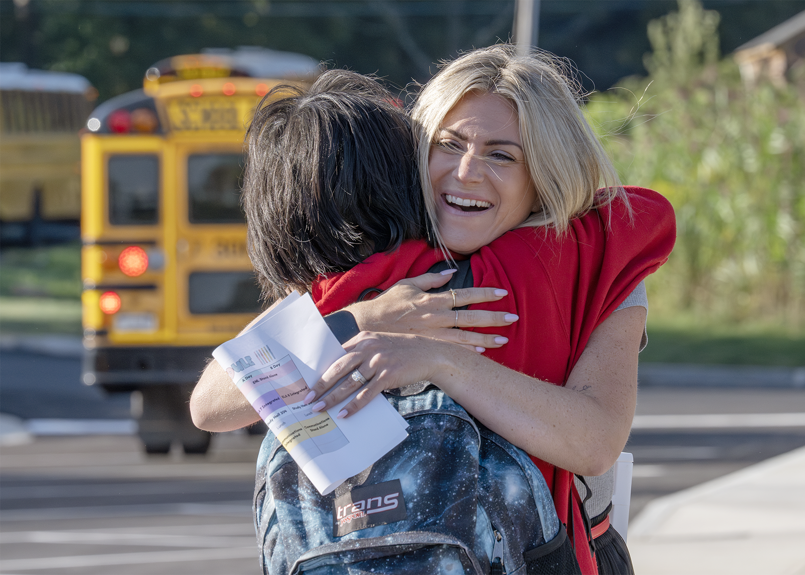 teacher hugs a student at middle school