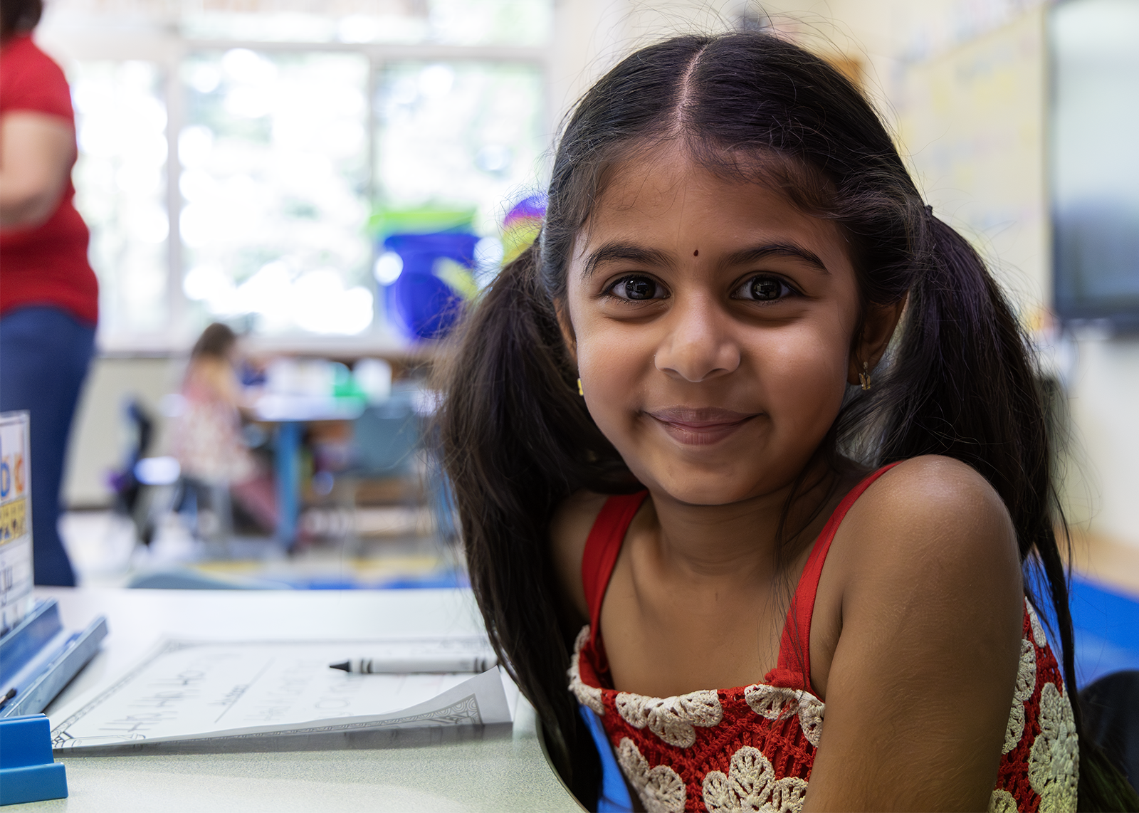 kinder student smiles at camera
