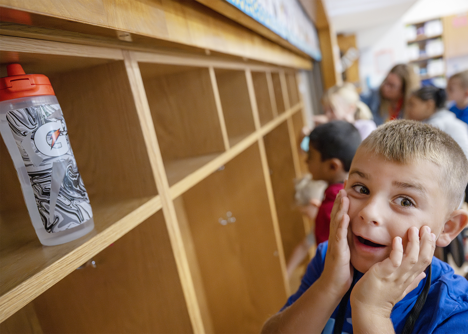 student holding cheeks surprised his water bottle fits