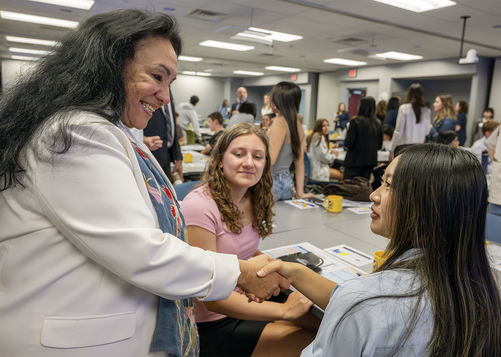 student board member shakes hand of NYSED commissioner