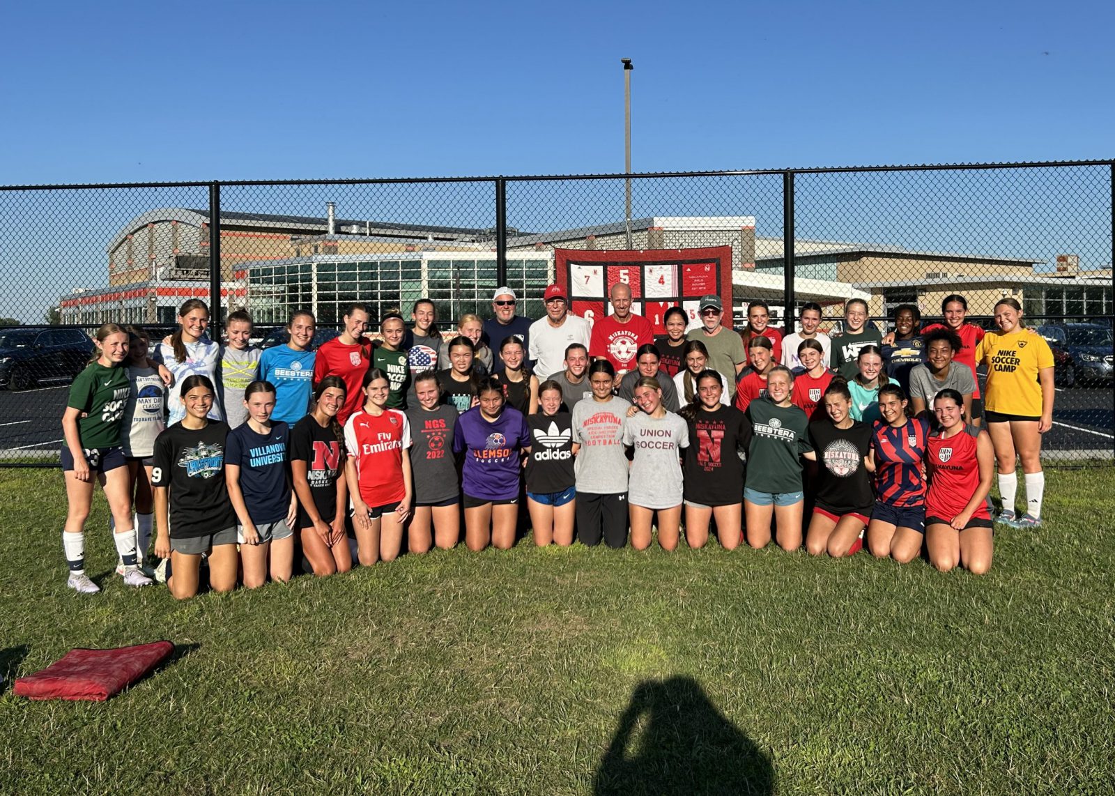 group of soccer players with three coaches