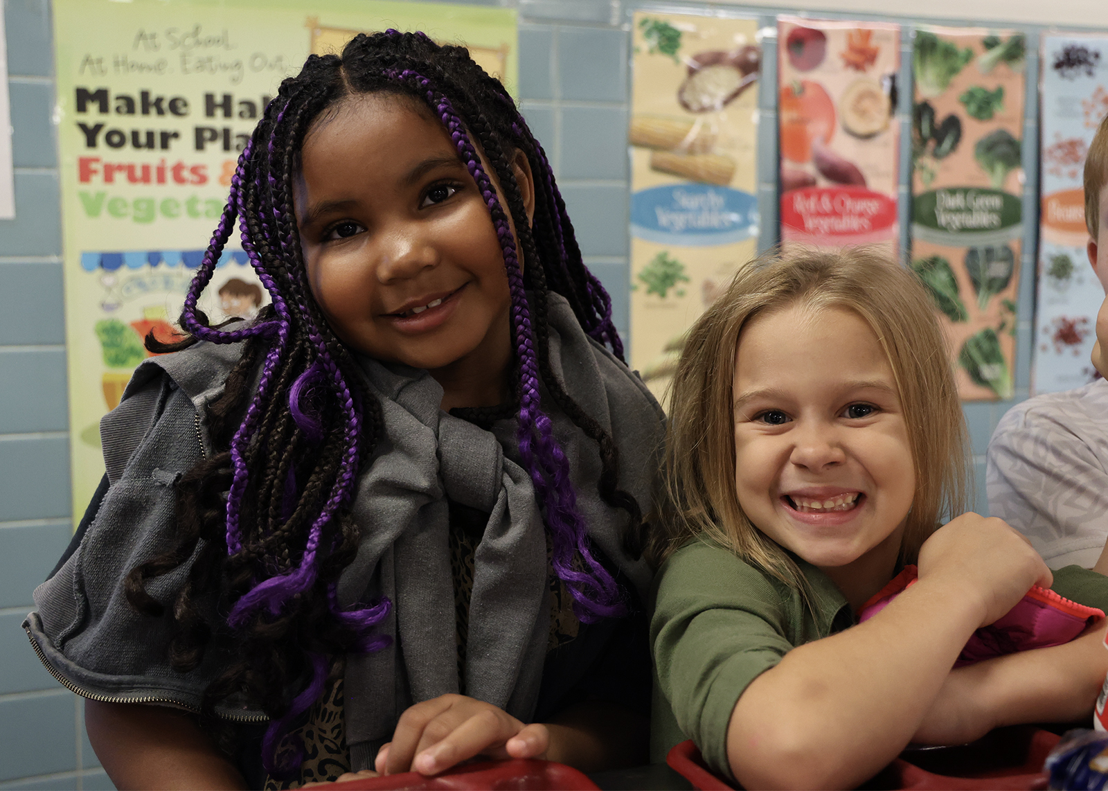two students smiling in lunch line