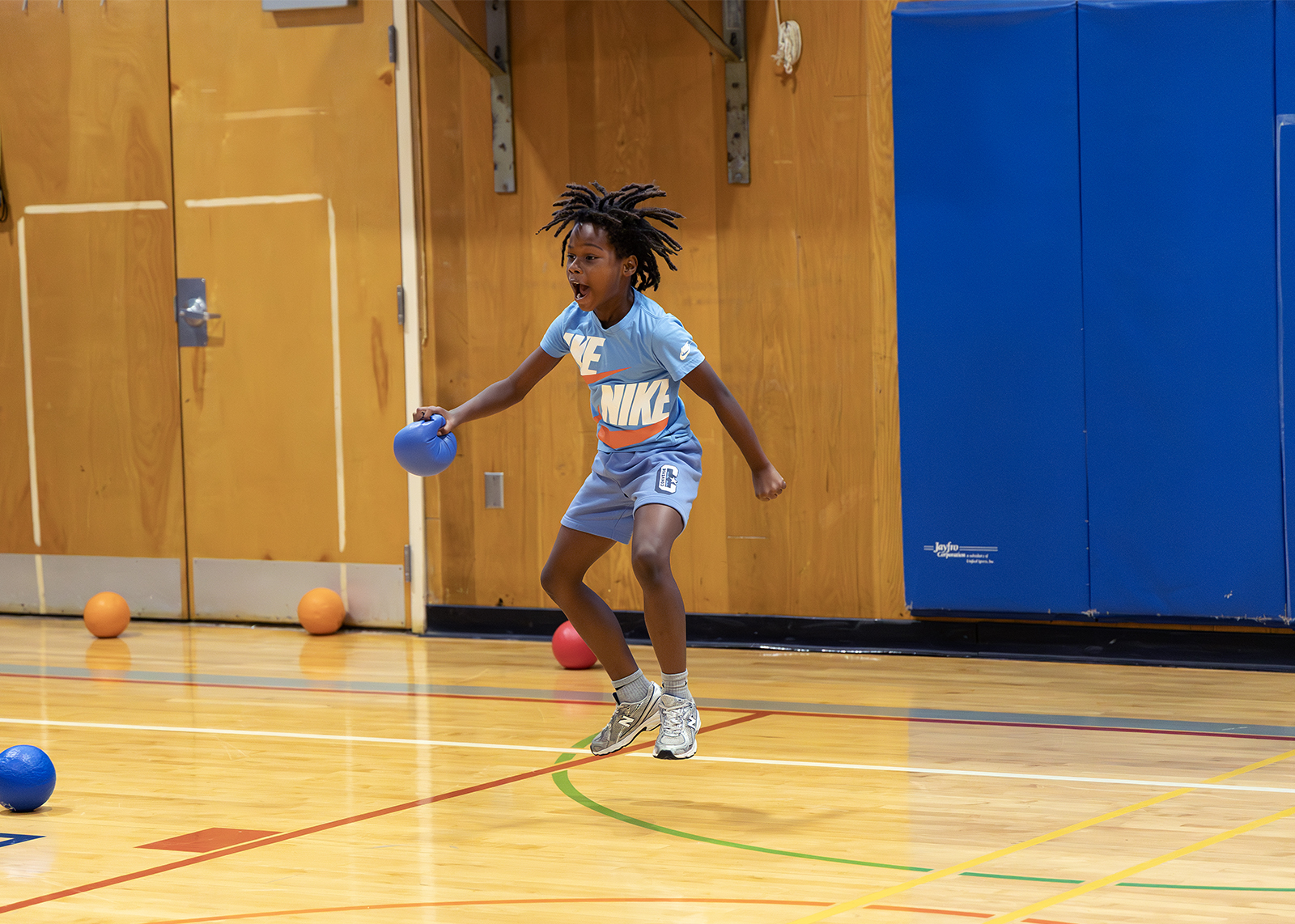 third graders jumps mid air in dodgeball