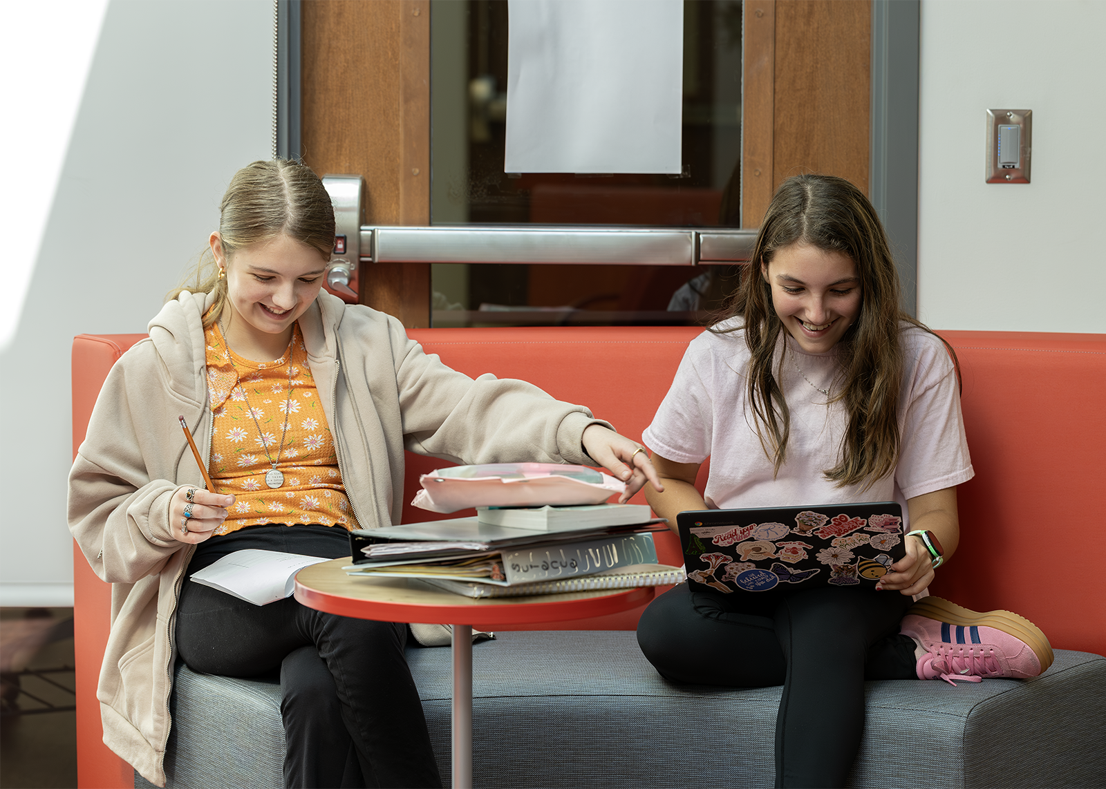 students on flexible seating doing library work