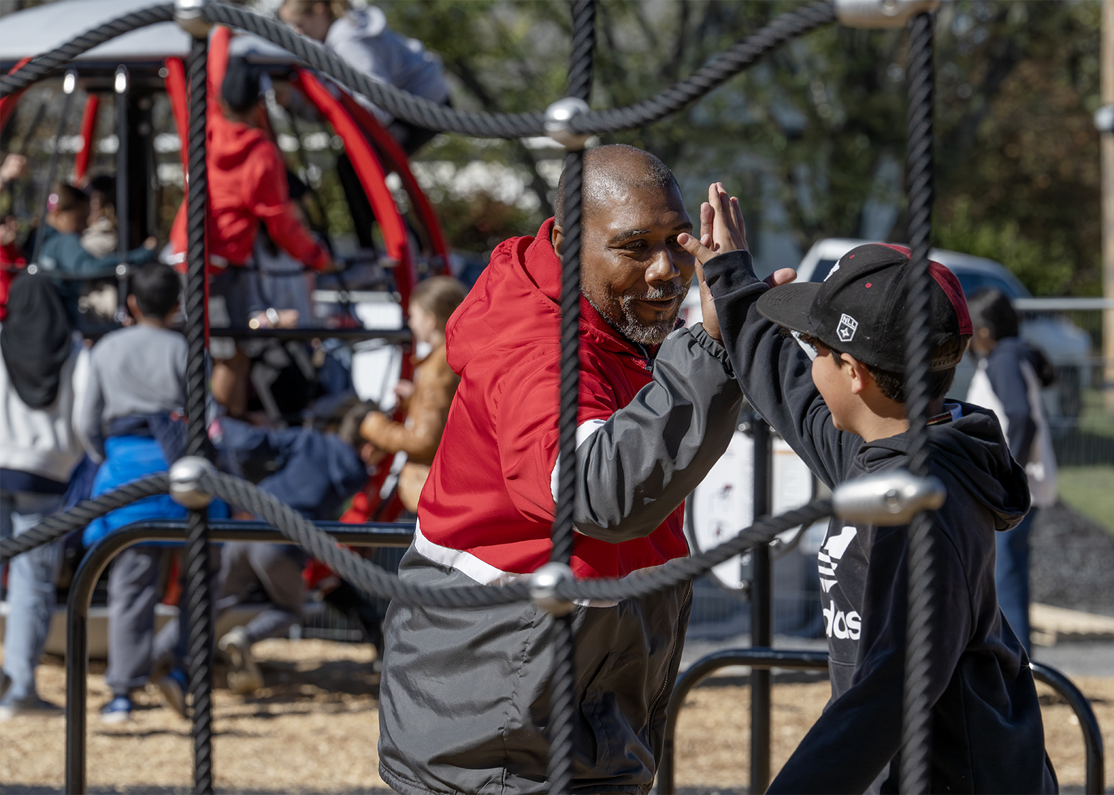 security guard high fives sixth grader on new playground