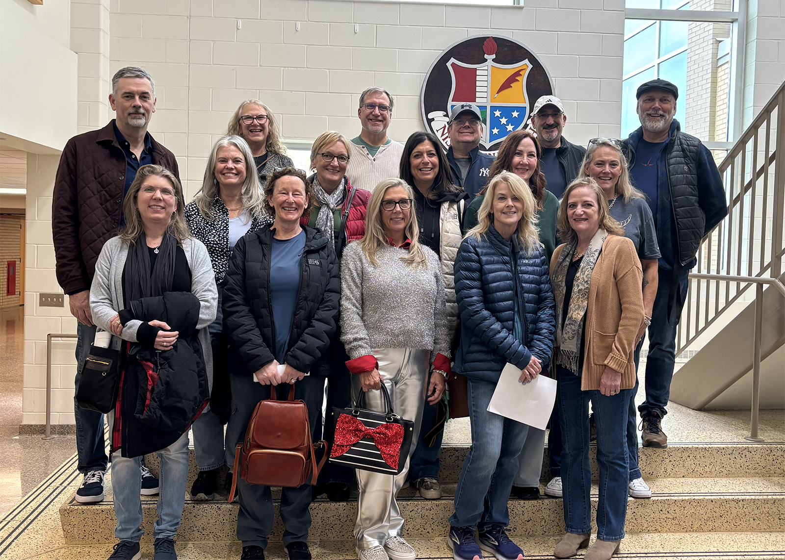 group of alumni smile in a group photo at Crossroads