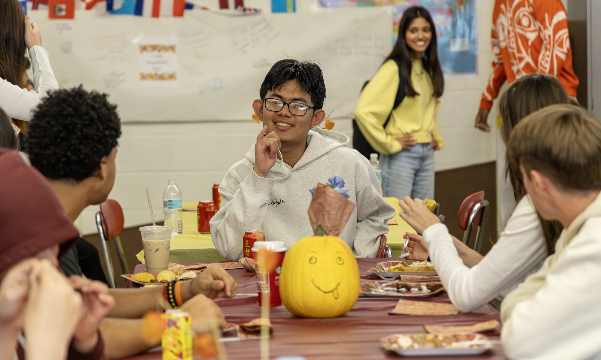 Niskayuna English as a new language students sit at a table together celebrating Thanksgiving