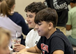 Student holding a yogurt parfait in the Iroquois Middle School cafeteria 