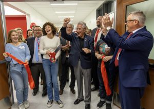 students cut the ribbon on the addition of Iroquois middle school with local officials and leadership and BOE behind them
