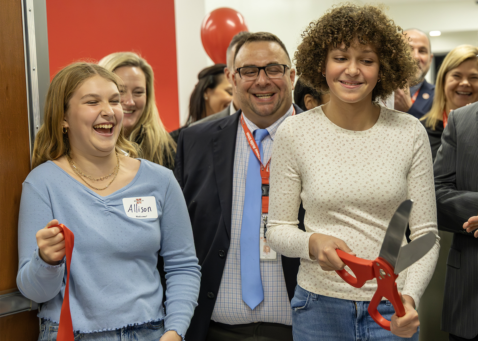 students cut the ribbon on the addition of Iroquois middle school with local officials and leadership and BOE behind them