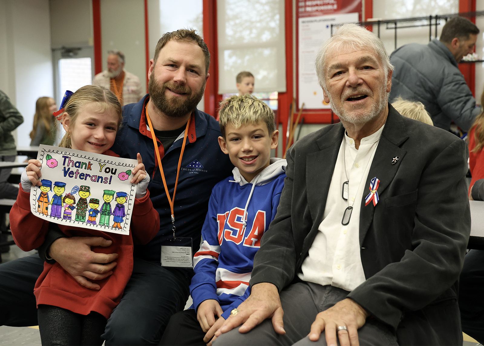 family smiles in cafeteria on veterans day