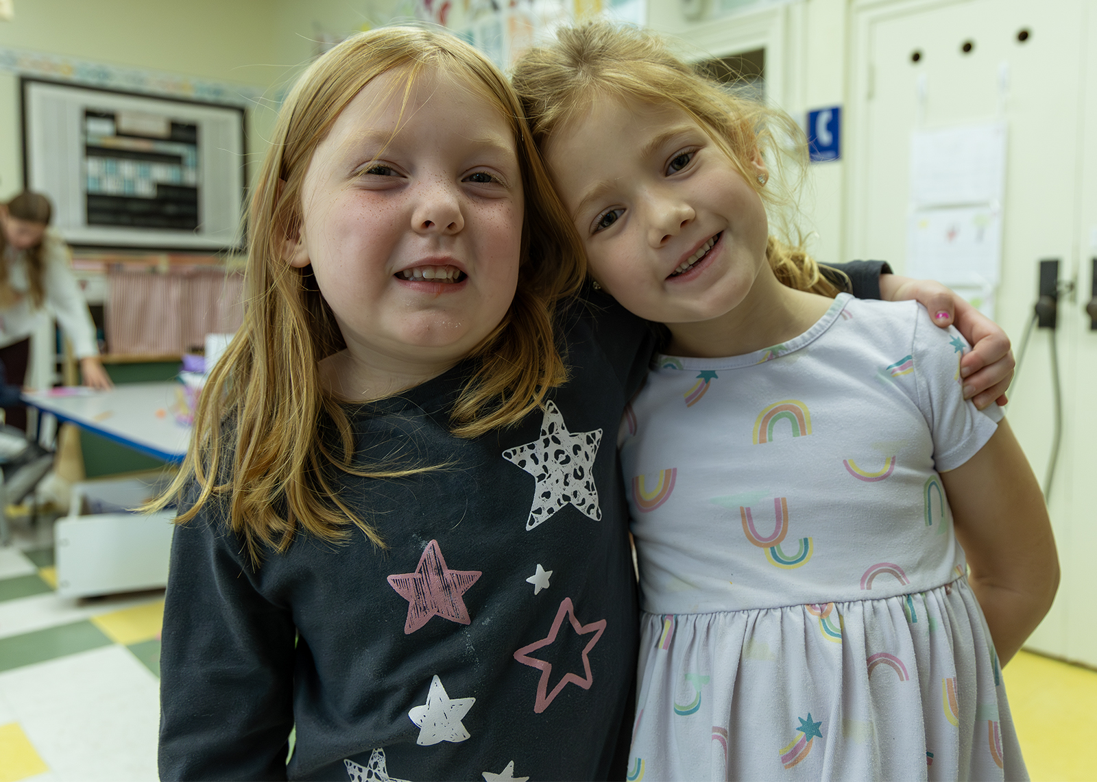 two kindergarten friends smiling at the camera