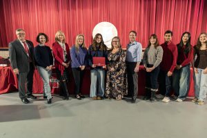 Student-athlete poses with board members.