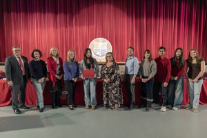 Student-athlete poses with board members.