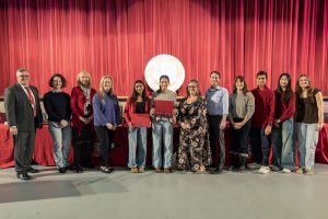 Board and student-athletes pose for group photos, two students are holding awards