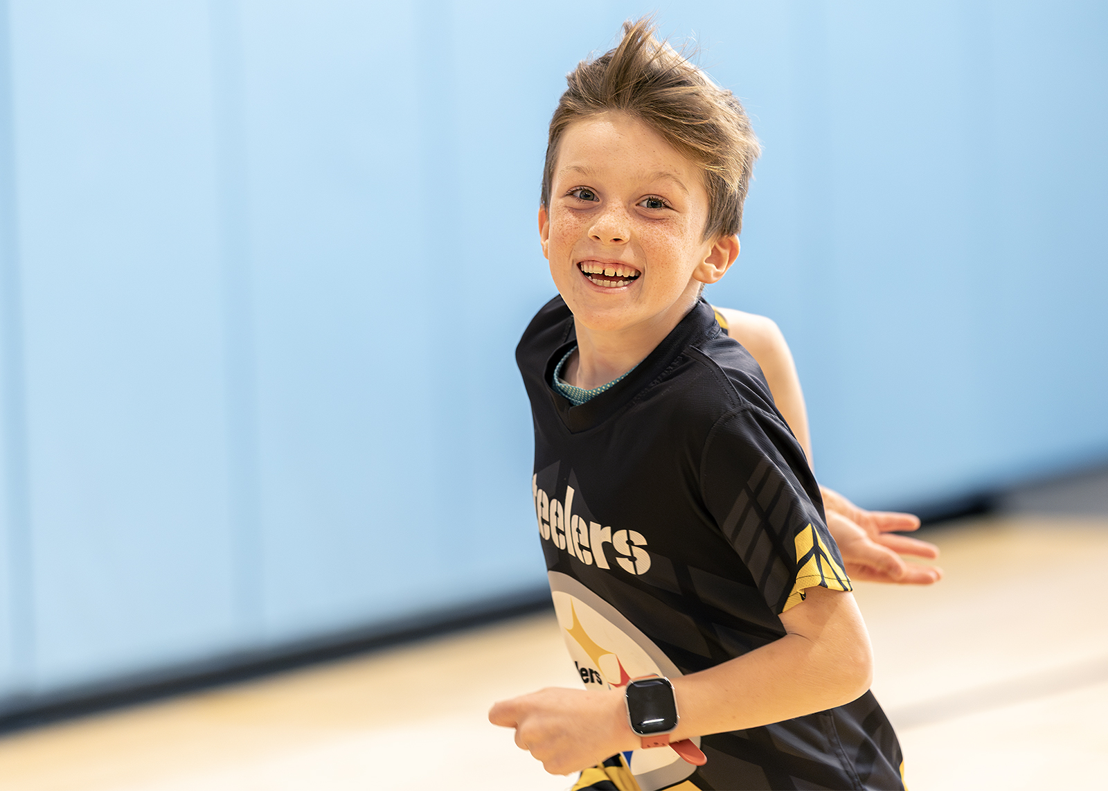 third grader running in PE