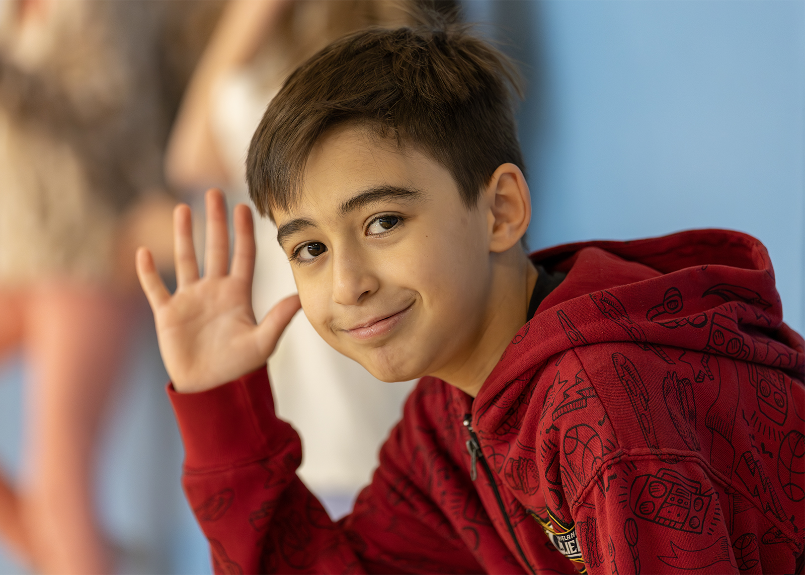 elementary student waving in gym