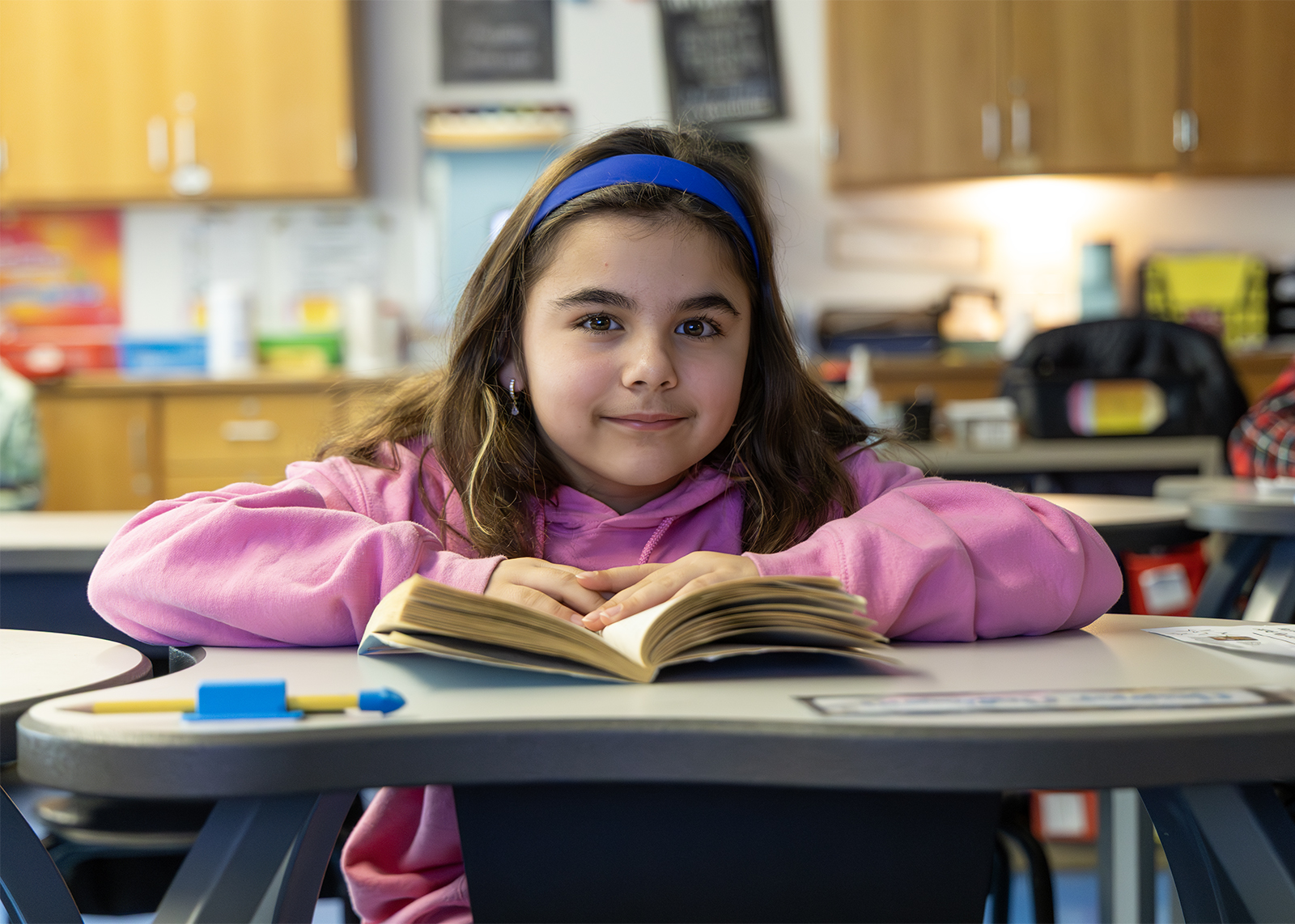 third graders looks up from book