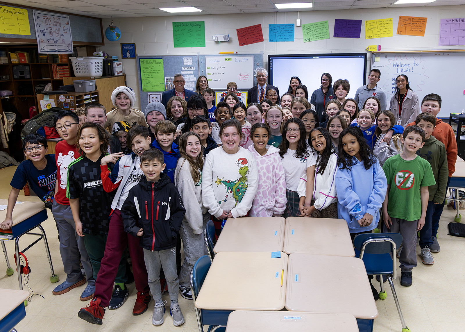 group of fifth graders with school leaders and league of women voters smiling at camera