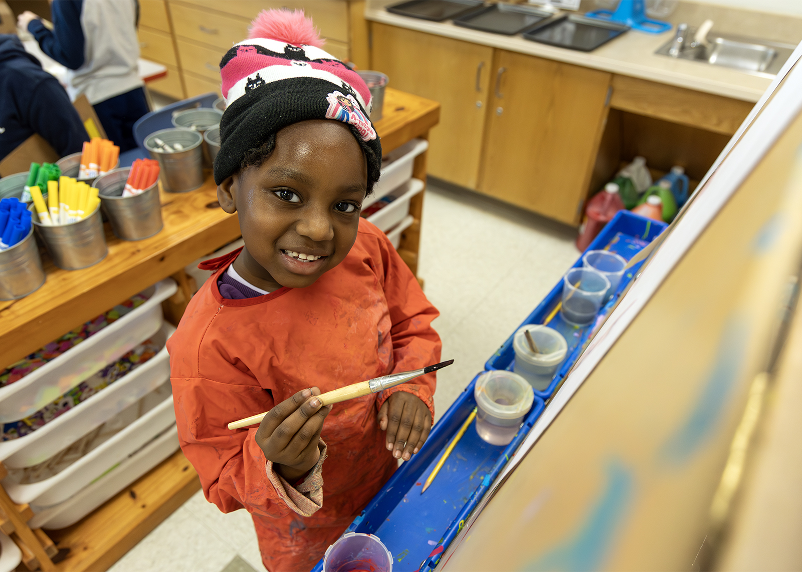 kindergarten at art easel