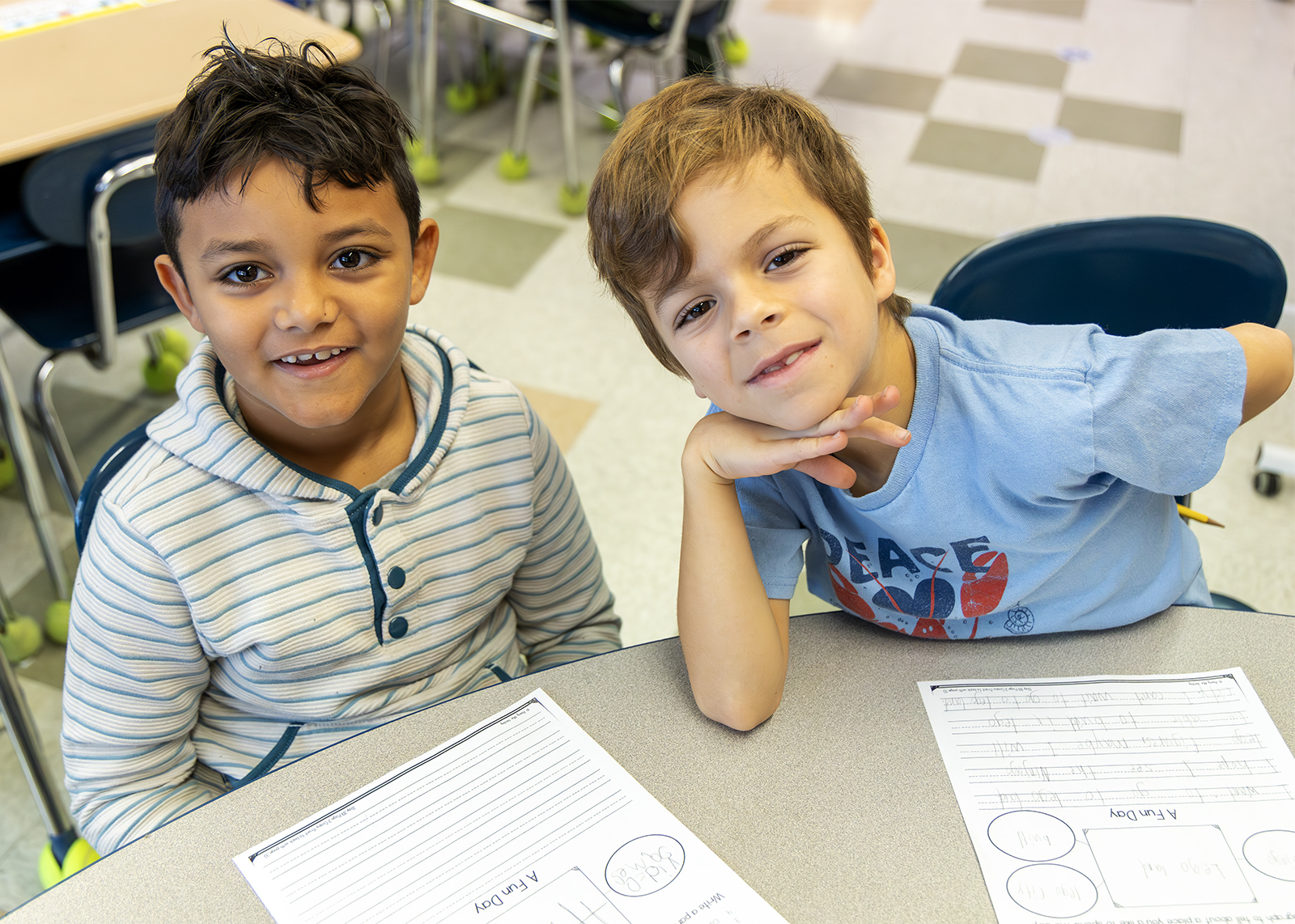 two second graders looking up at camera smiling