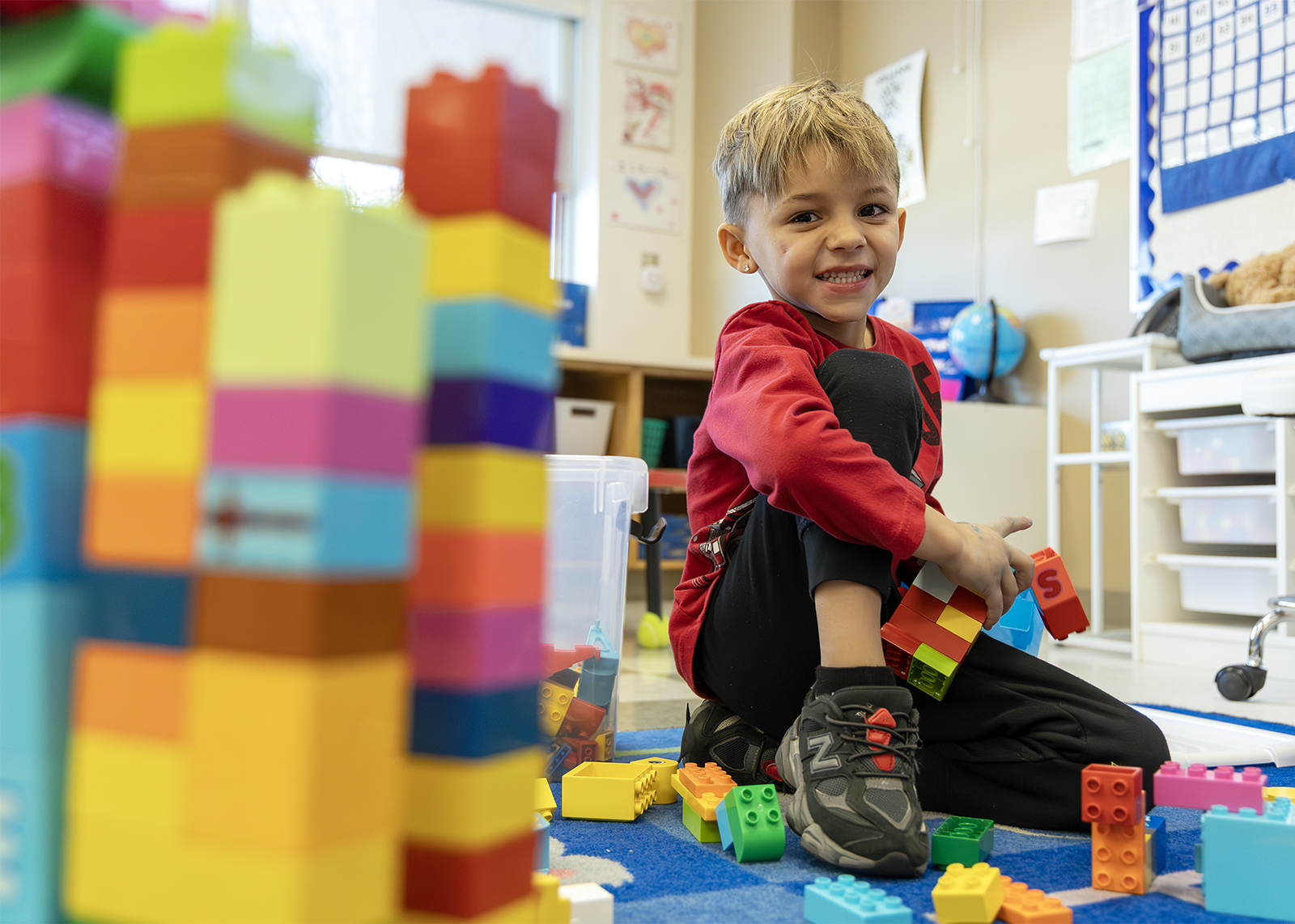 kindergartener building lego bricks