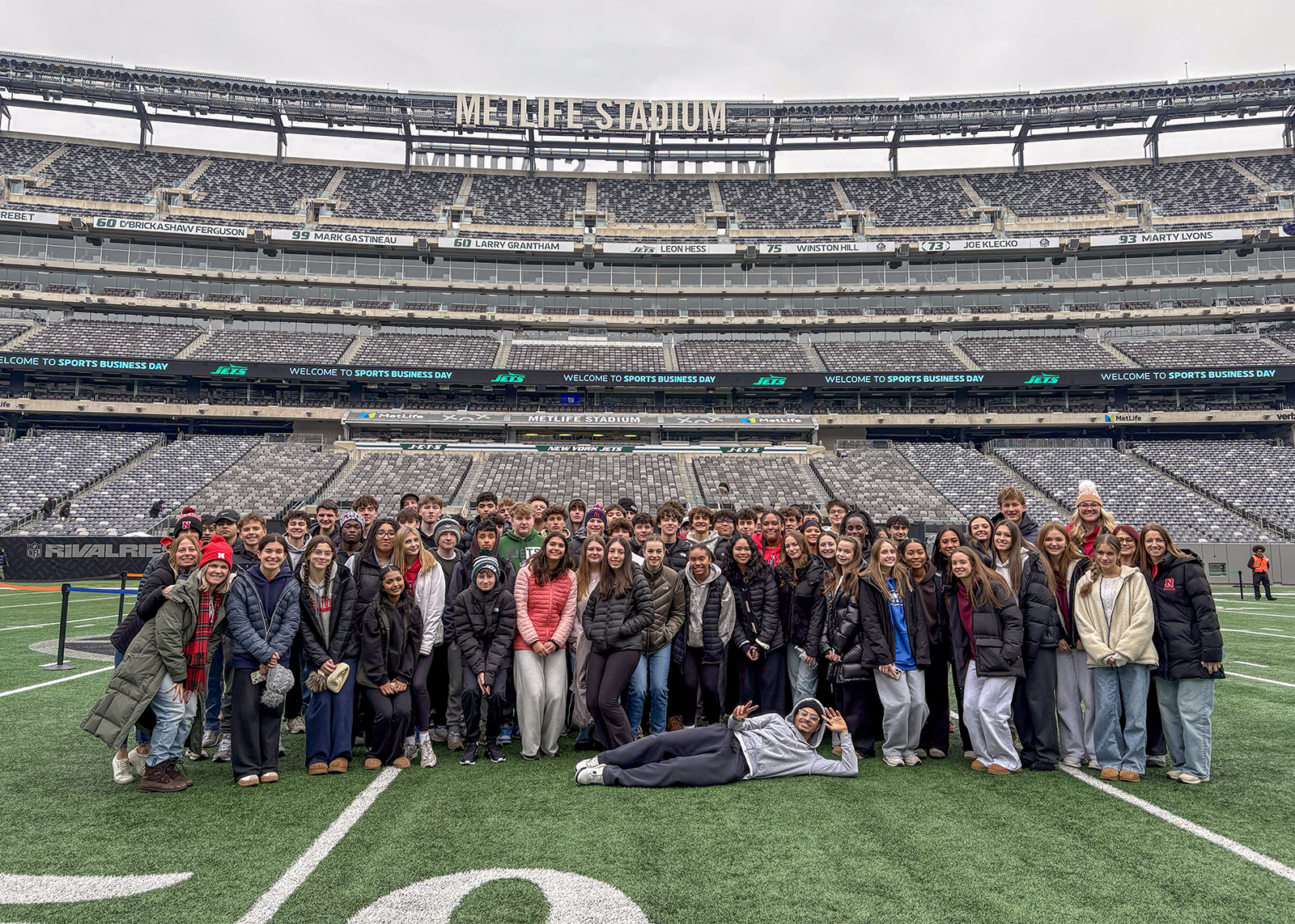 Marketing and Sports Management class group photo at 50 yard line in MetLife stadium