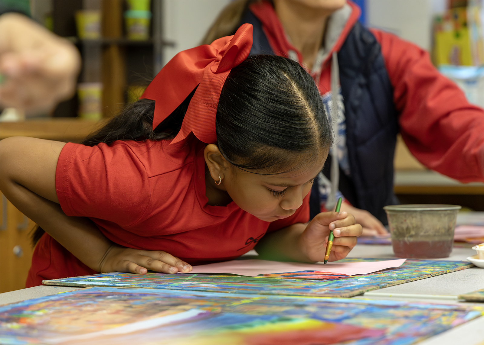 ES student in art class looking at project
