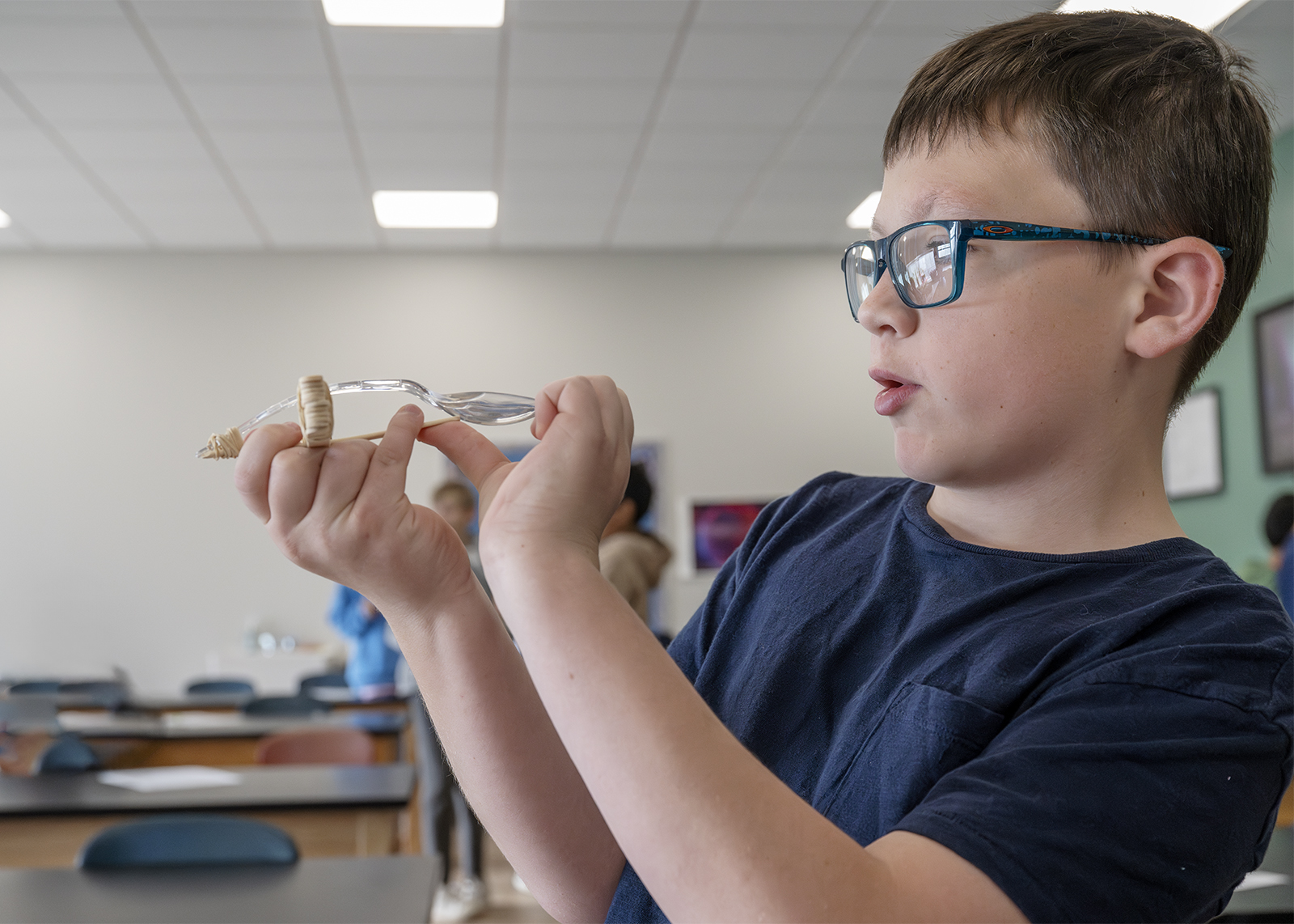 sixth grader building a spoon catapult