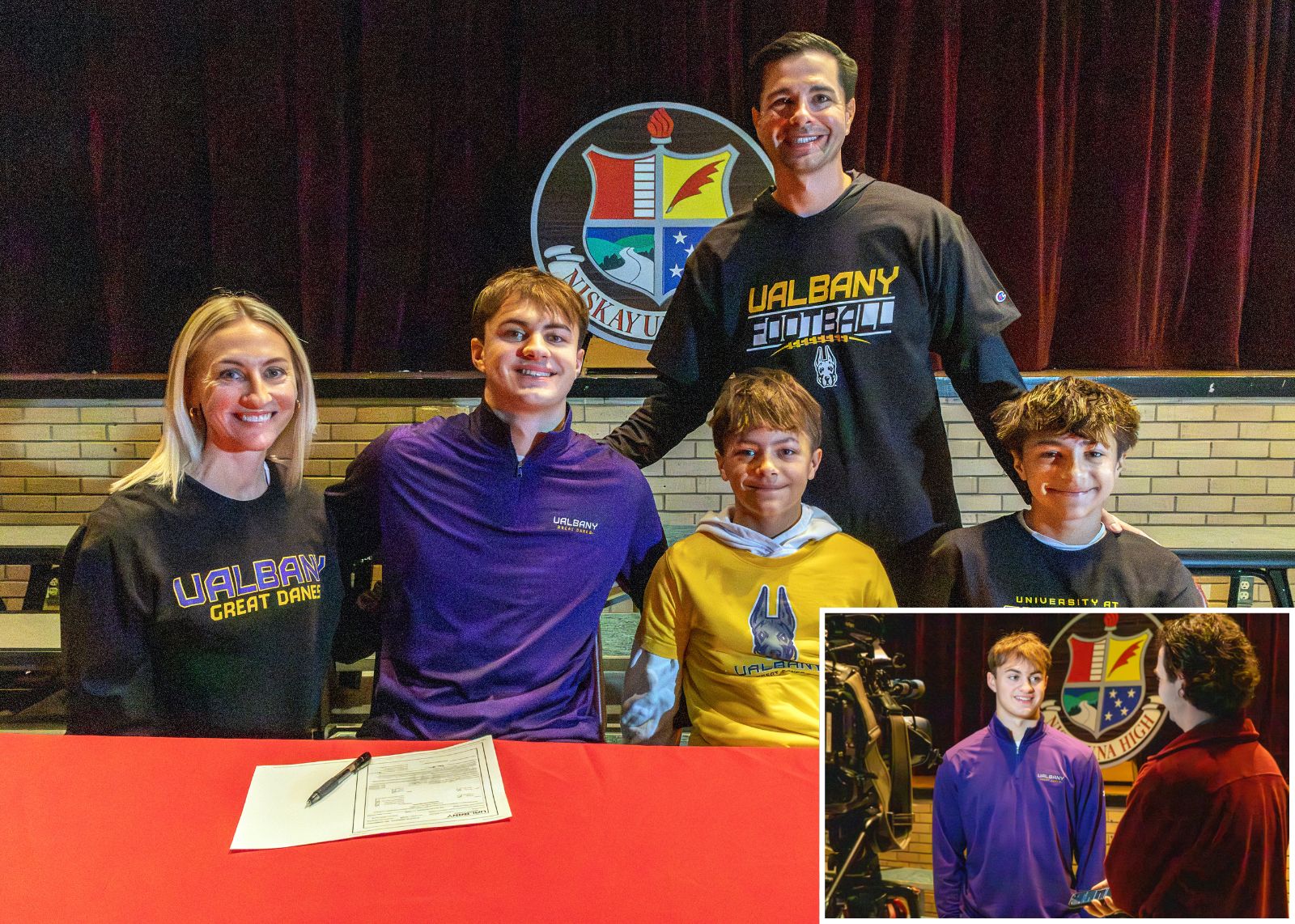 family smiles at camera for signing ceremony