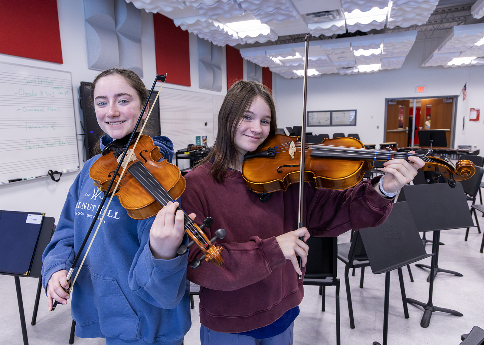 two middle school students playing viola back to back