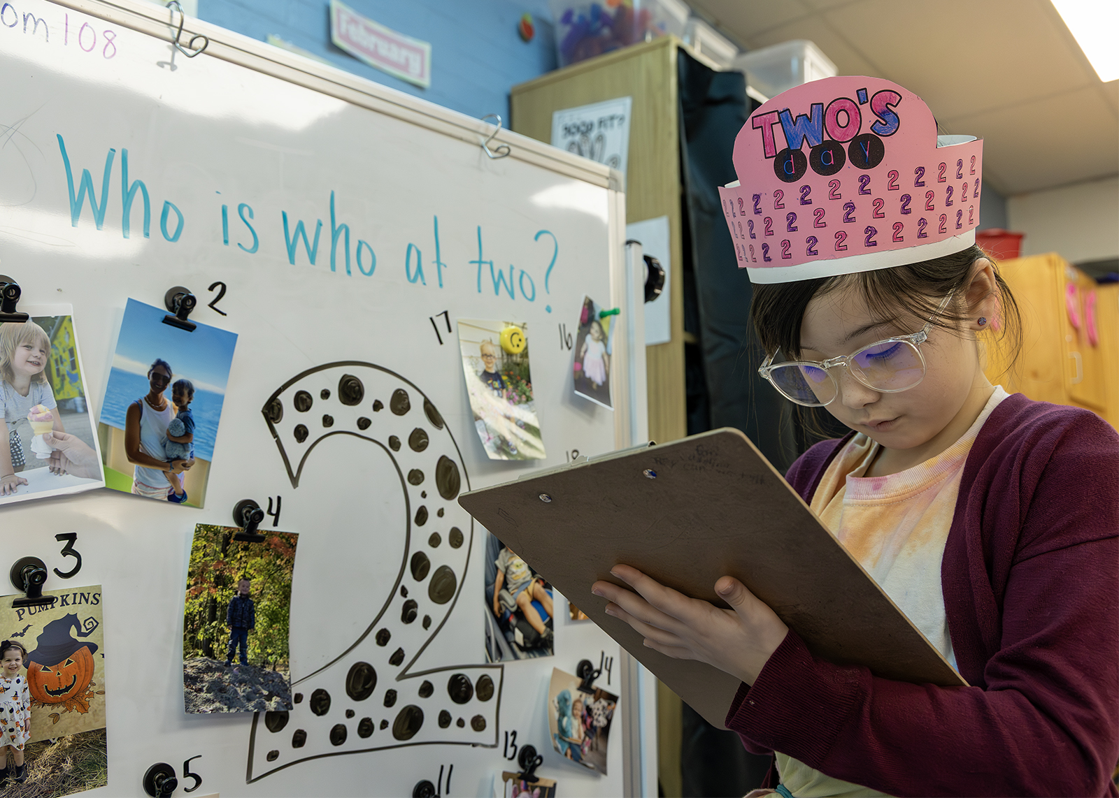second grader holding a clipboard in class