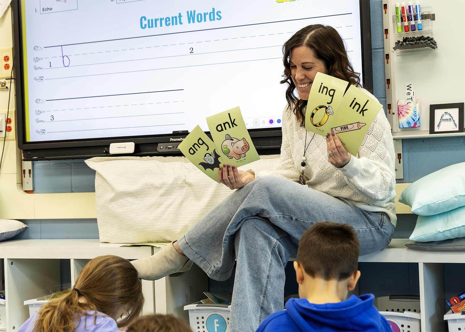 elementary teacher holds up ELA flashcards