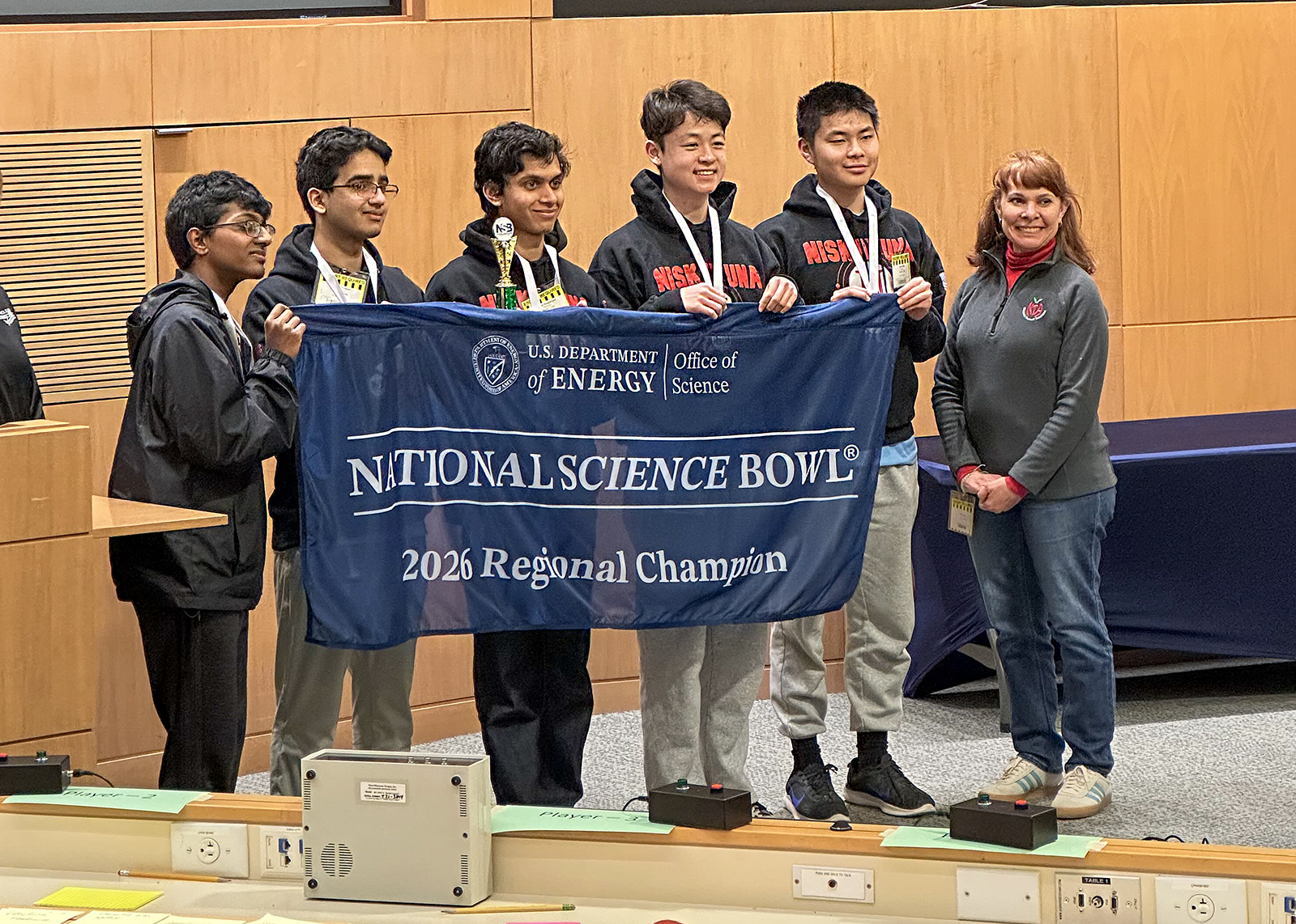 science bowl team holding up regional championship banner