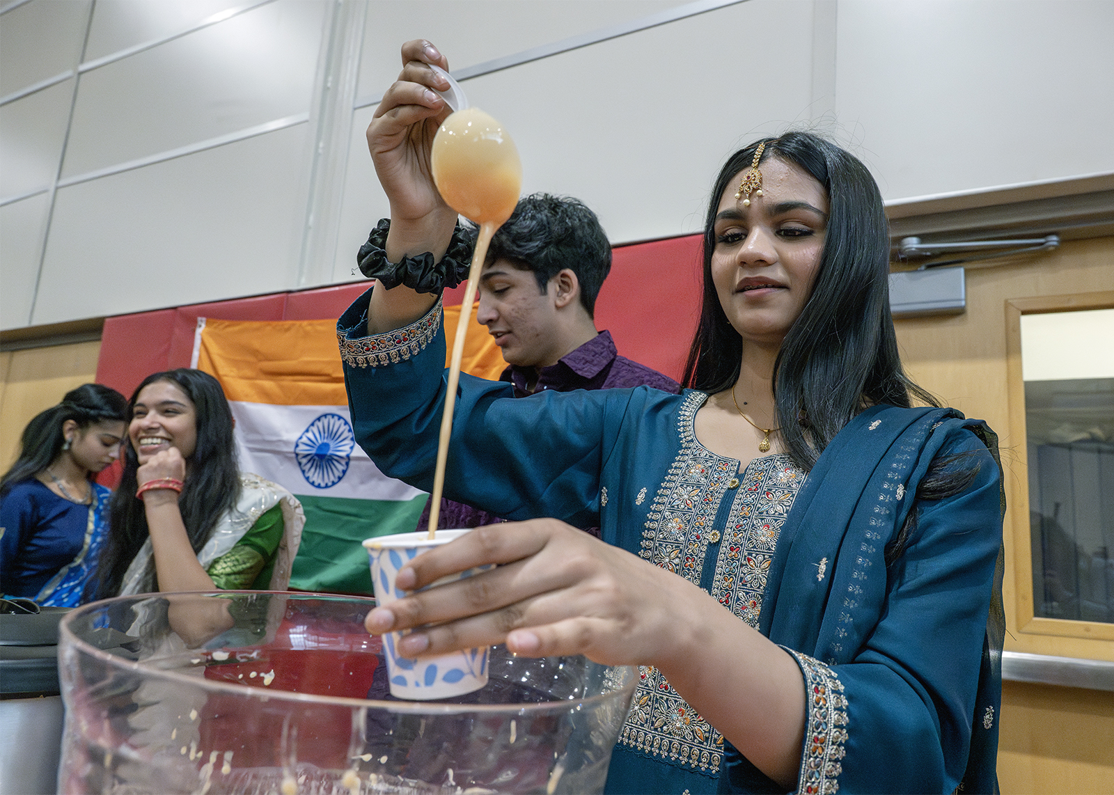 students at multicultural fair sharing punch