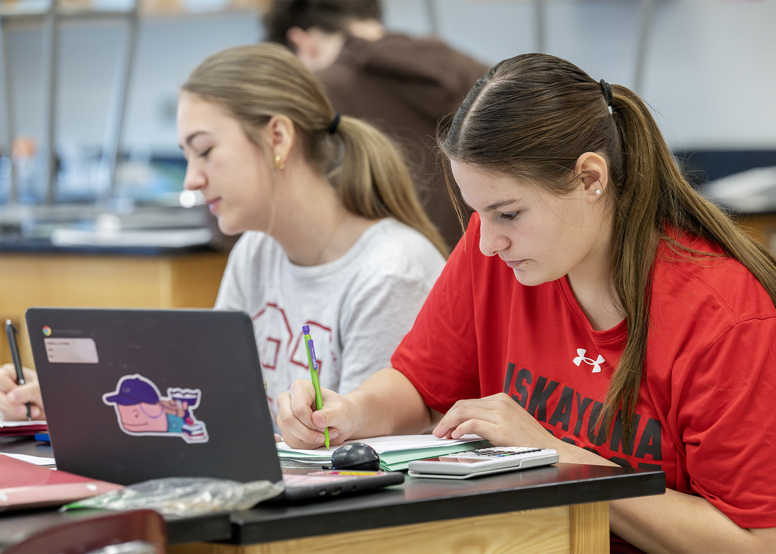 HS students working in class with laptop and calculator