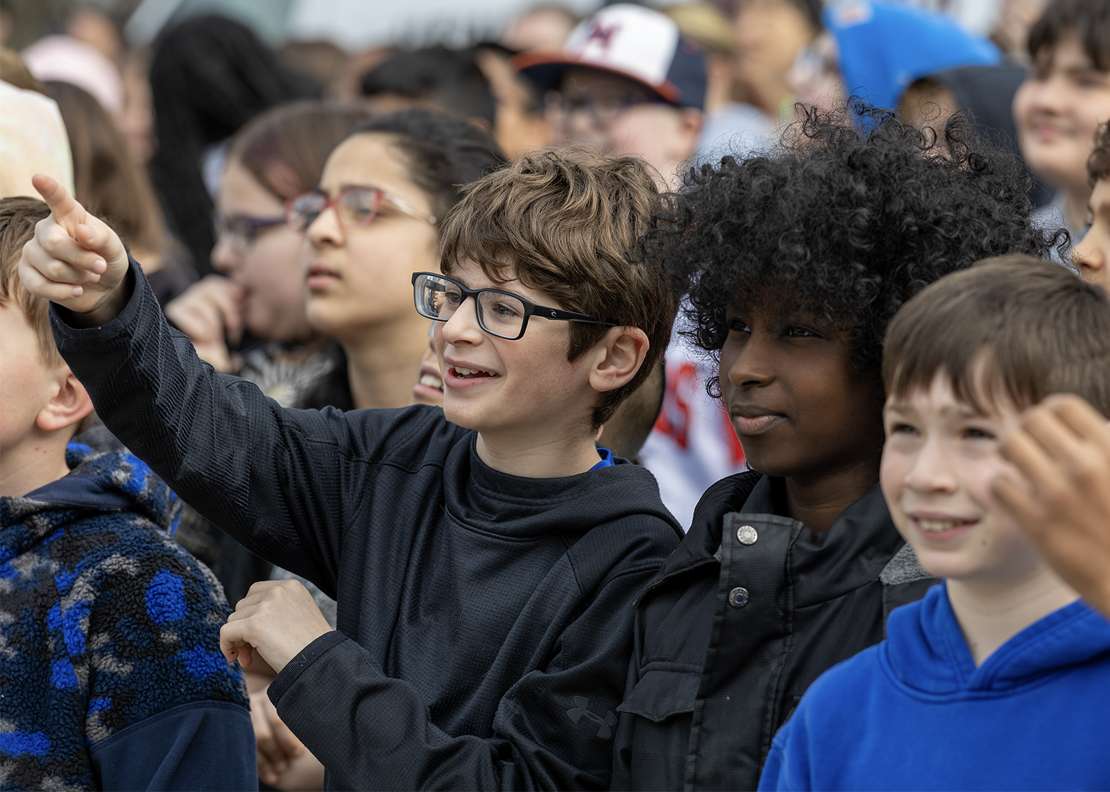 two sixth graders looking up at construction site smiling and pointing