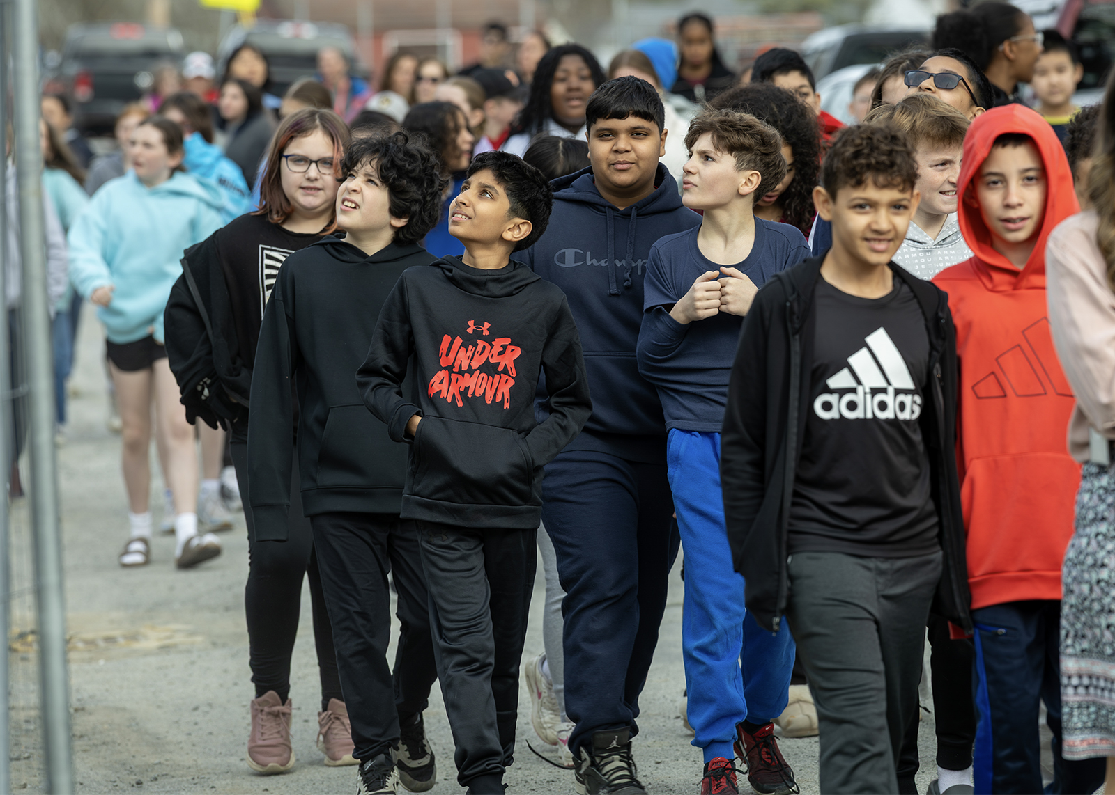 group of sixth graders looking up at construction site
