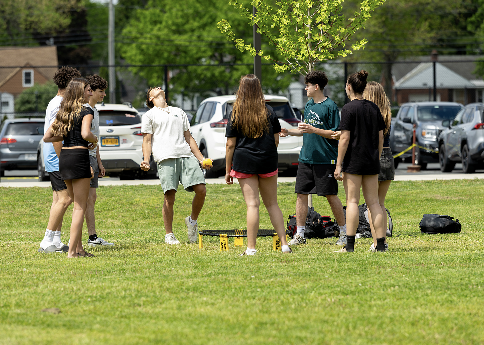 high school kids on green playing spikeball