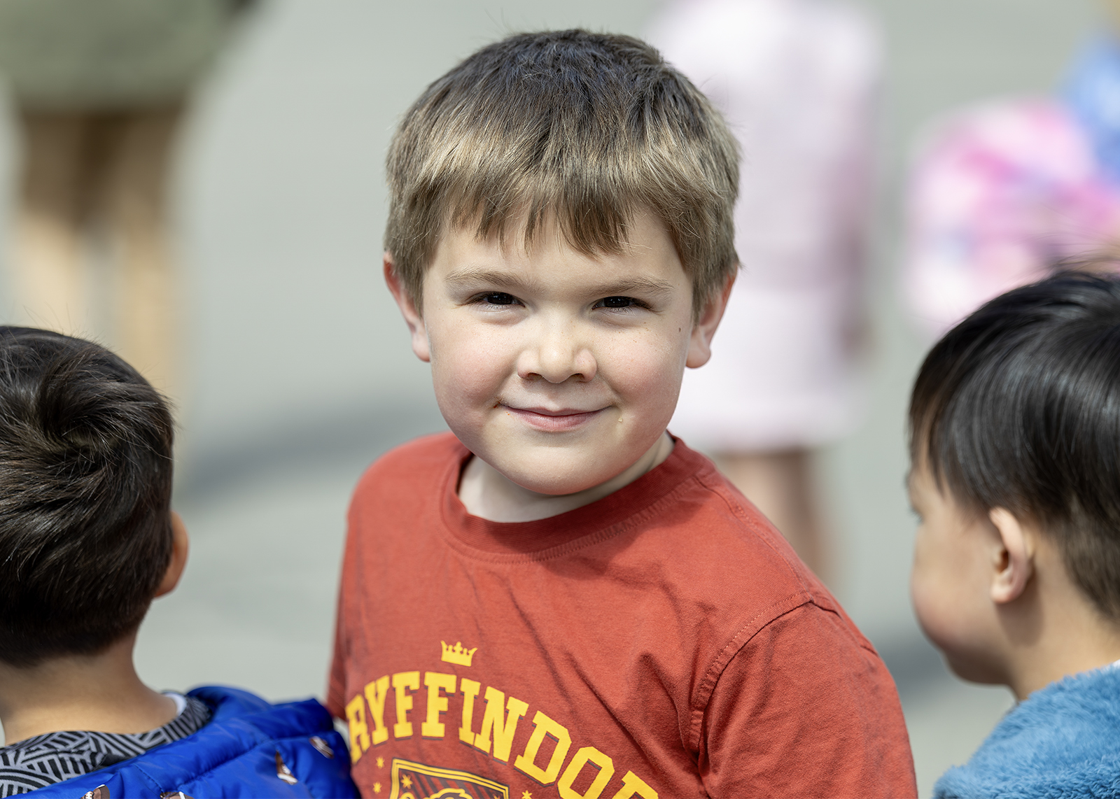 elementary student smiling at camera while outside