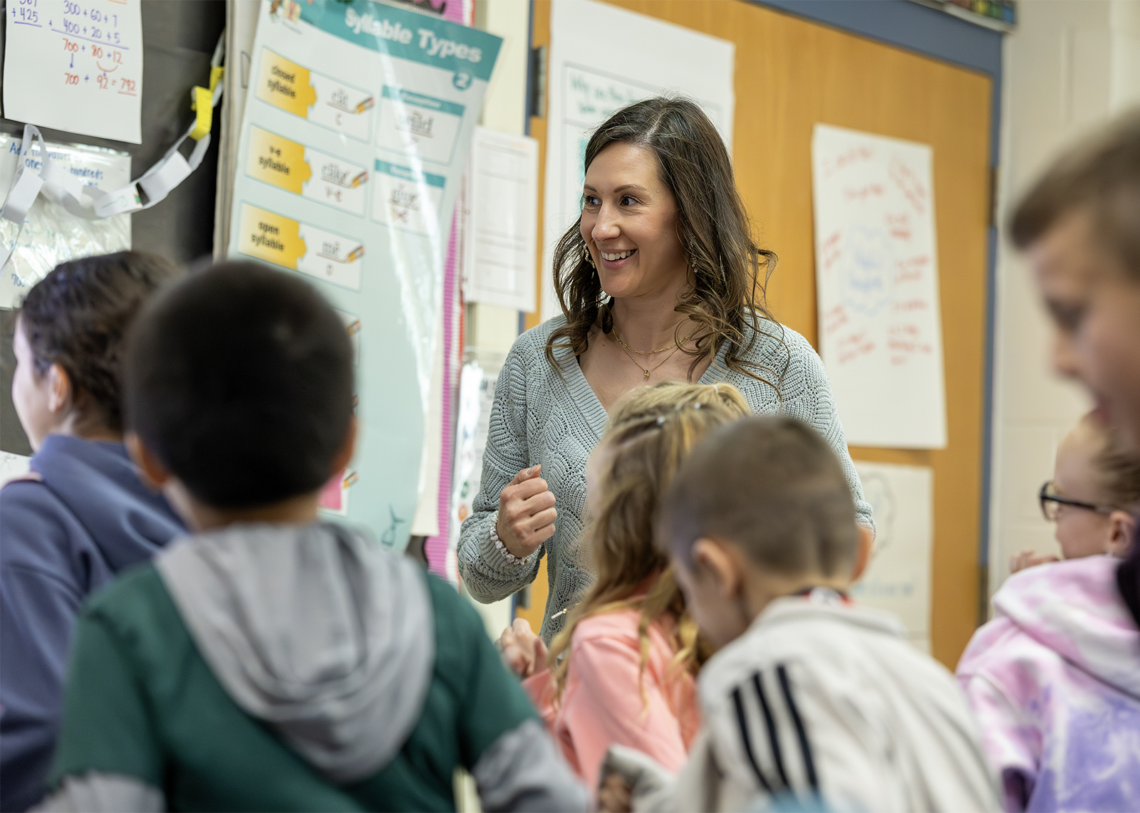 teacher smiling while teaching students