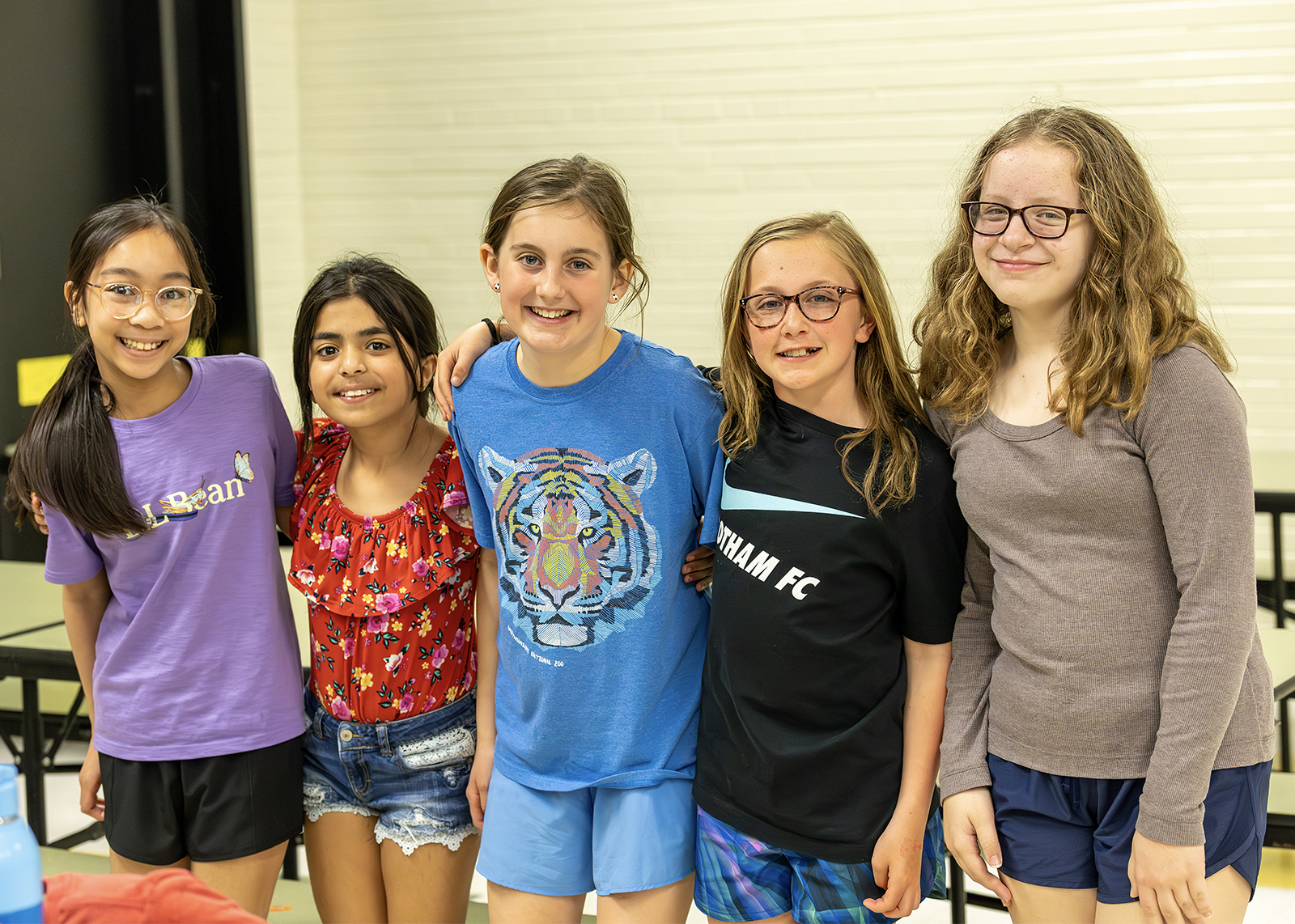 group of elementary students smiling in the cafeteria