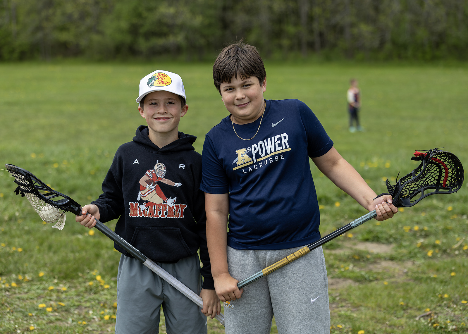 elementary students holding lacrosse sticks