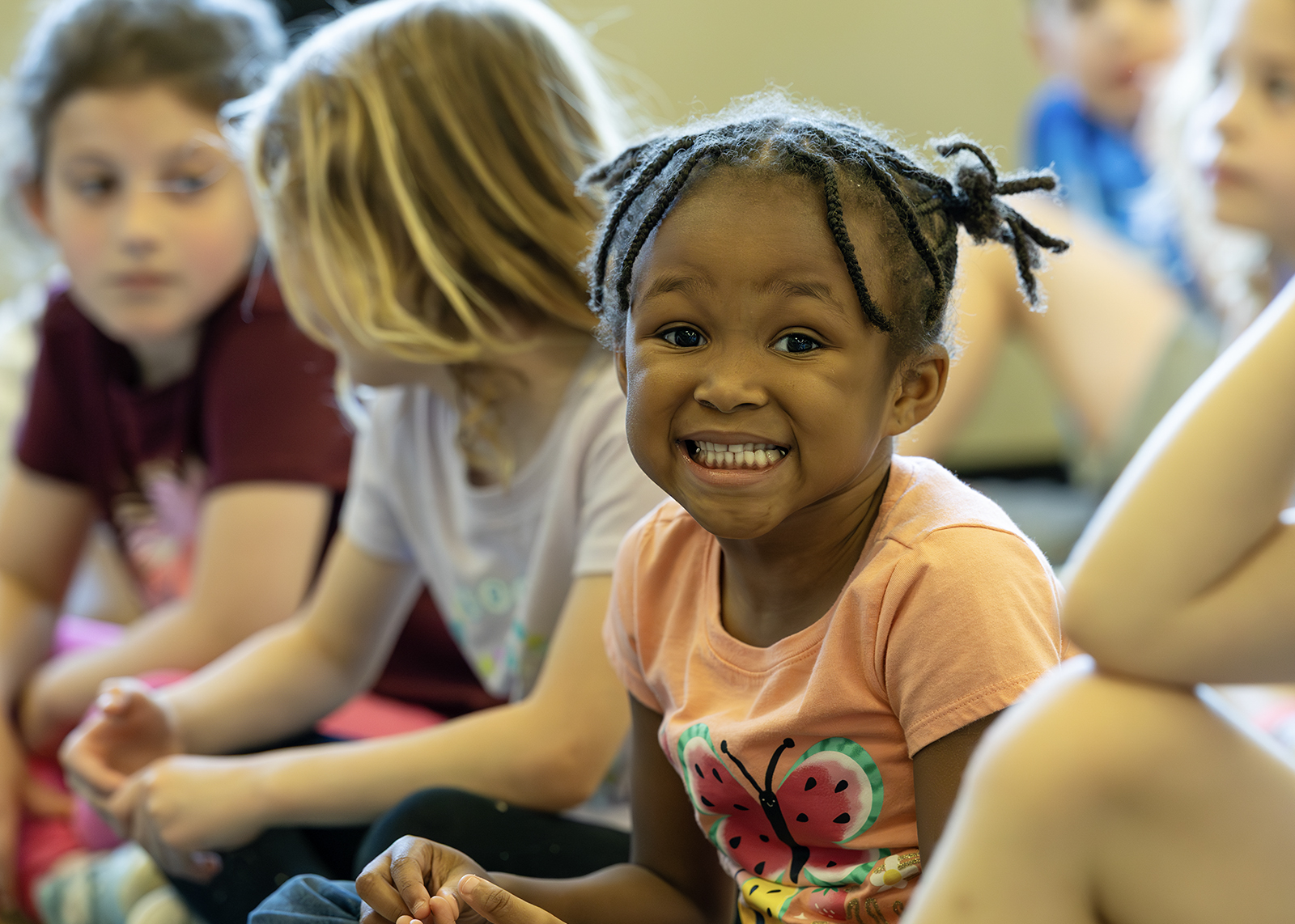 elementary student in library smiling at camera